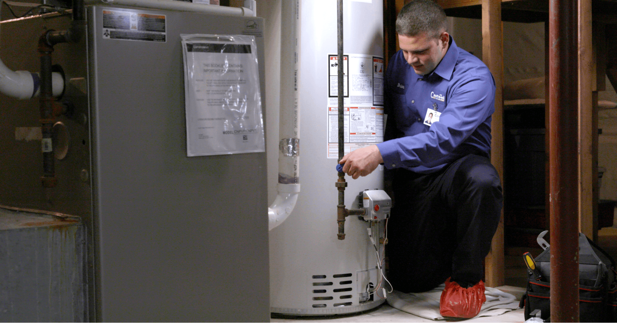 technician draining a water heater