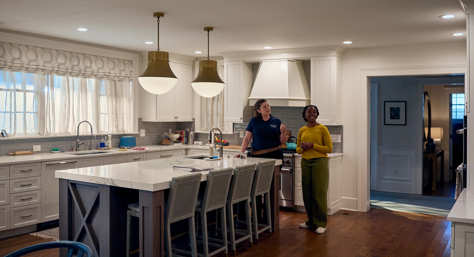 A Weeks electrician consulting with a homeowner about modern residential lighting design and complete home electrical services.